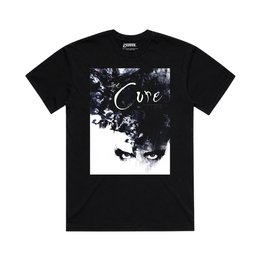 A black short-sleeve crewneck t-shirt featuring a large square graphic print on the front. The graphic is a high-contrast black and white artistic portrait of a face with the words 'the Cure' written across it.