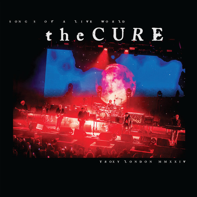 Concert image with 'the Cure' band on stage, featuring a large screen and red lighting.