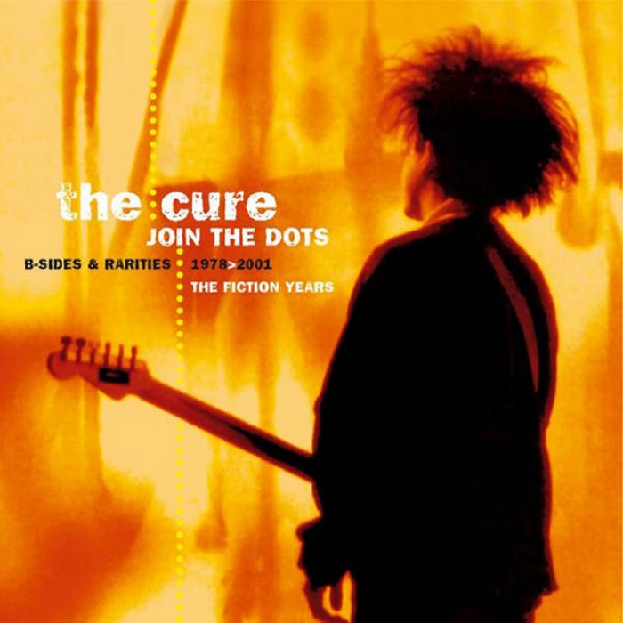 Album cover for 'The Cure' featuring a silhouette of a person with a guitar against an orange background.